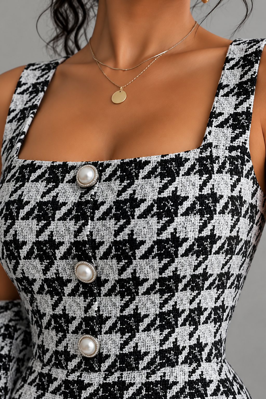 Close-up of black and white houndstooth tweed dress details