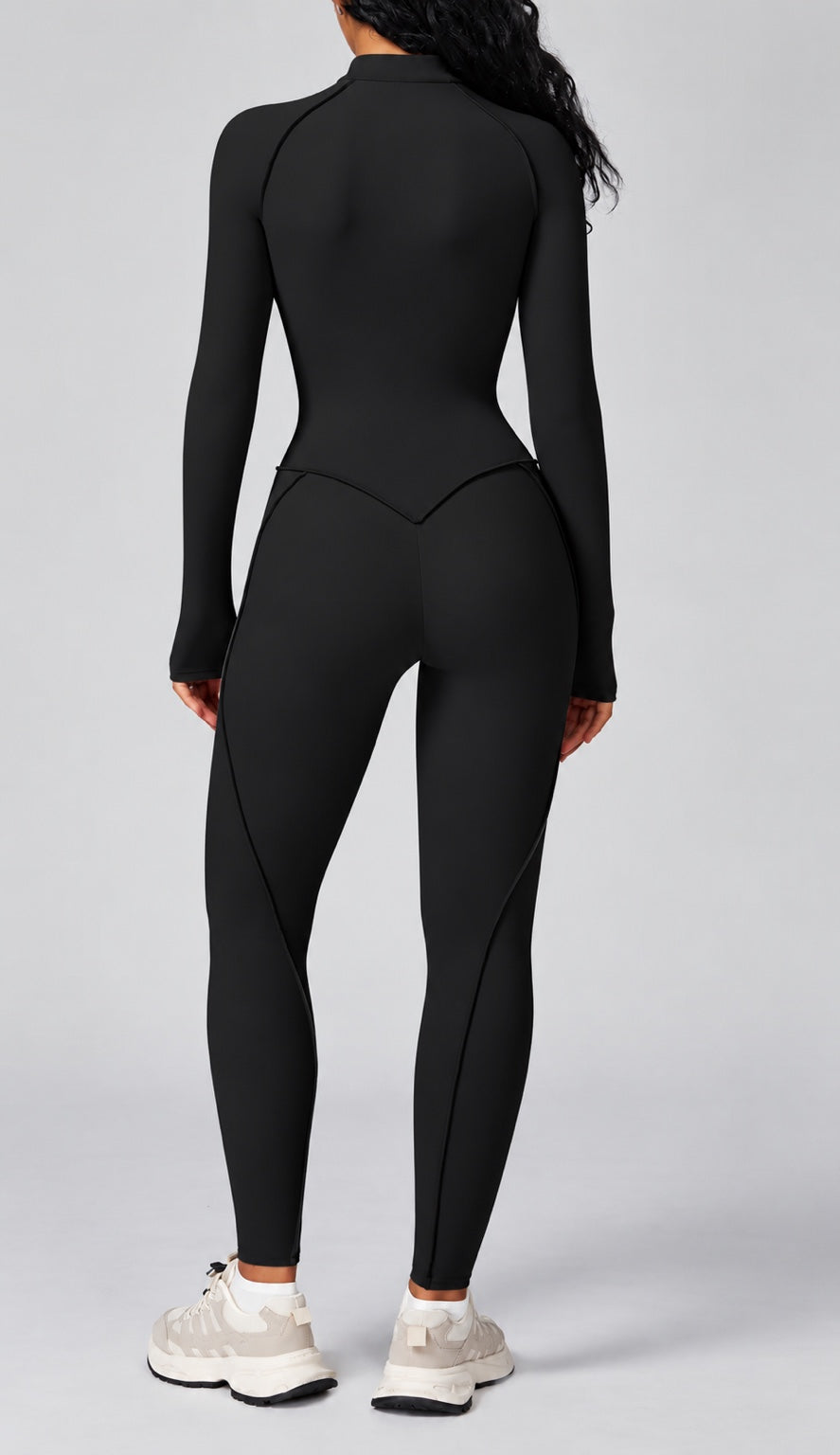 Black women's sculpting zip front active jumpsuit back view
