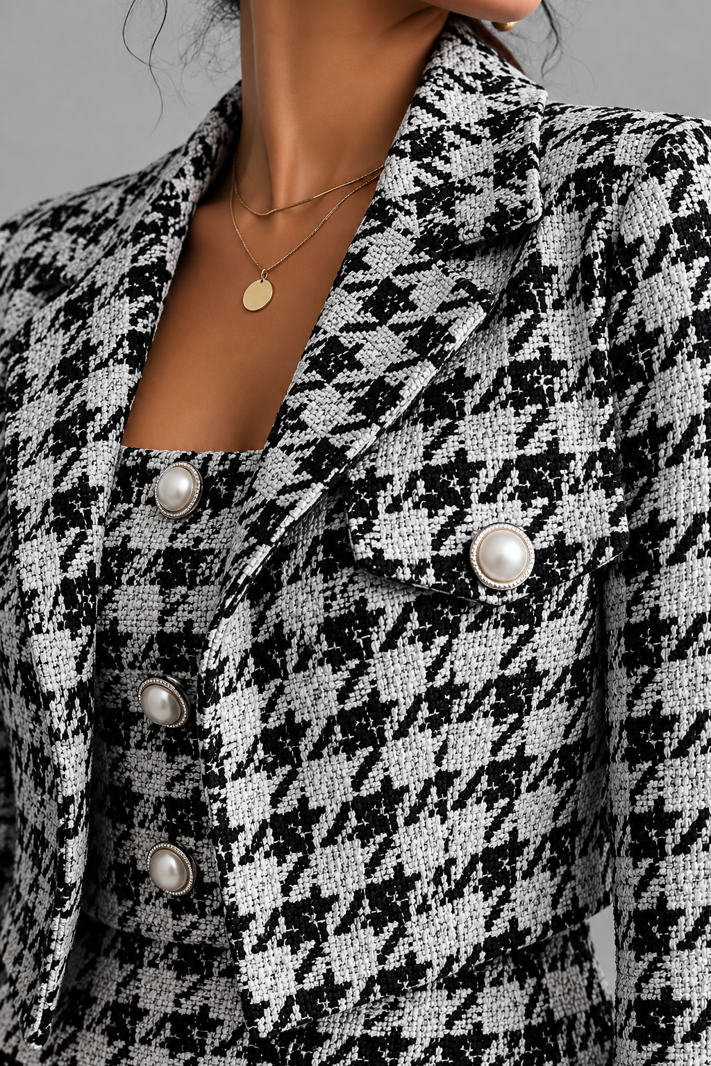 Close-up of black and white houndstooth tweed blazer details